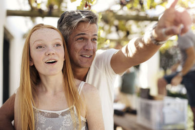 Father showing something to daughter outdoors