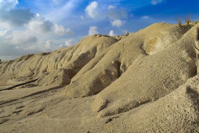 Panoramic view of sand dune on beach against sky