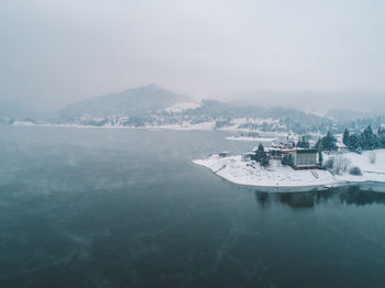 Scenic view of lake against sky during winter 