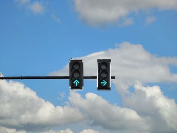 Low angle view of road signal against blue sky