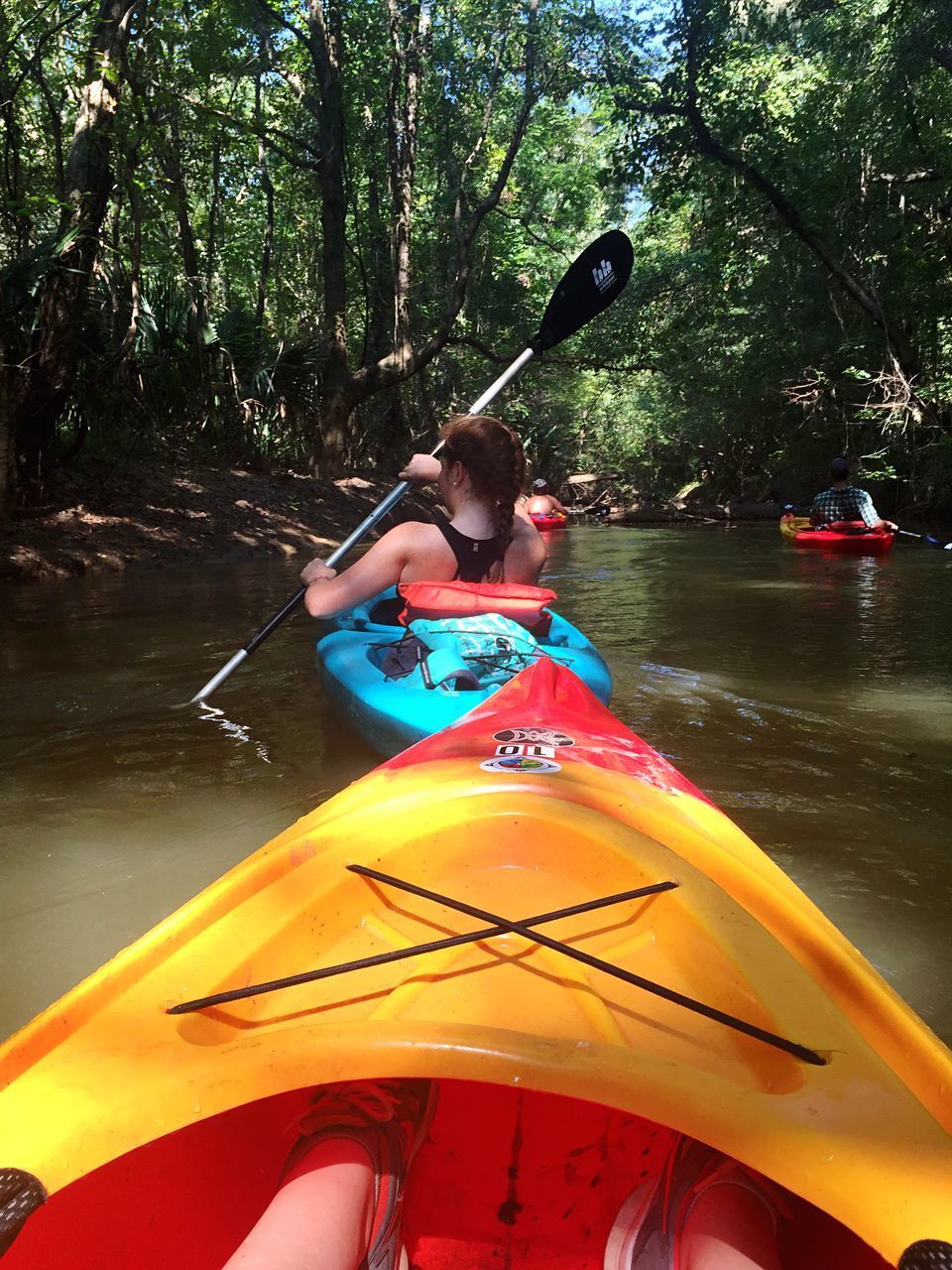 REAR VIEW OF MAN AND WOMAN IN BOAT