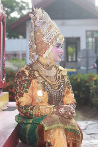 Woman in traditional clothing sitting on steps