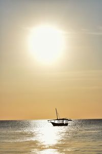 Silhouette boat in sea against sky during sunset