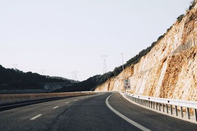 Empty road against clear sky