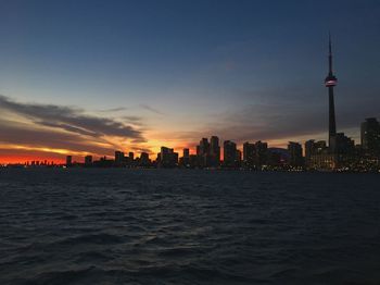 View of buildings in city at sunset