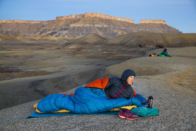 People watch sunrise from camp in factory butte badlands, utah