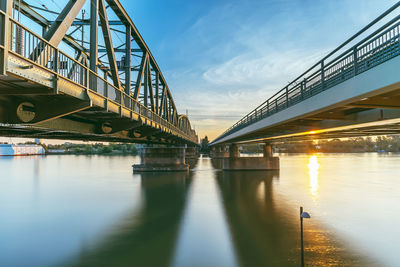 Low angle view of bridge over river against sky