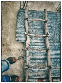 Low section of man standing on wood