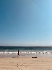 Woman on beach against sky