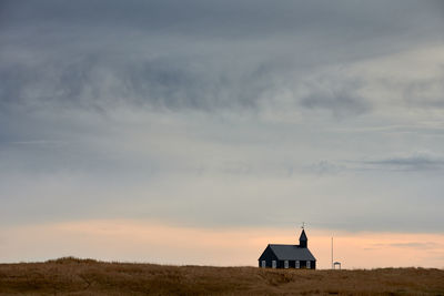 Church building against sunset sky