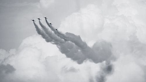 Low angle view of airplane flying against sky