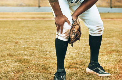 Low section of man running on field