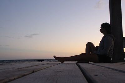 Rear view of people sitting on beach