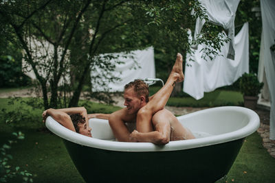 Couple in bathtub outdoors