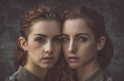 Portrait of siblings against wall