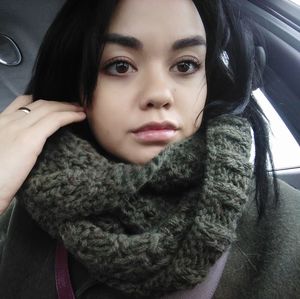 Close-up portrait of young woman in car