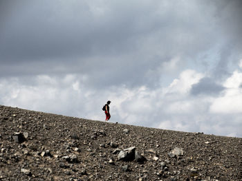 Silhouette of woman against cloudy sky