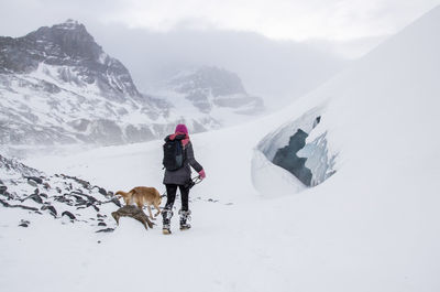 Rear view of woman on snow covered mountain