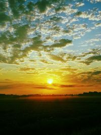 Scenic view of field against sky during sunset