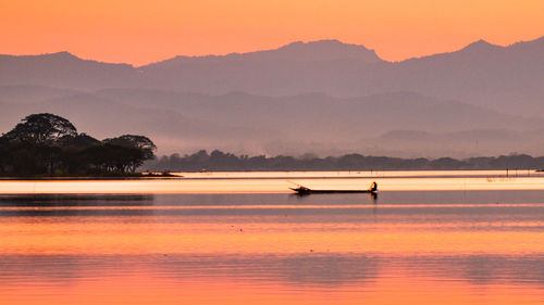 Scenic view of lake against sky during sunset