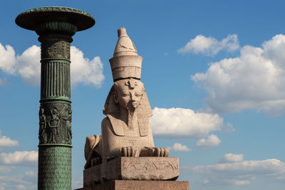 Low angle view of statue against cloudy sky