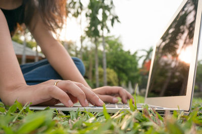 Midsection of woman using laptop