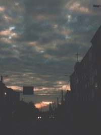 Illuminated city against sky at sunset