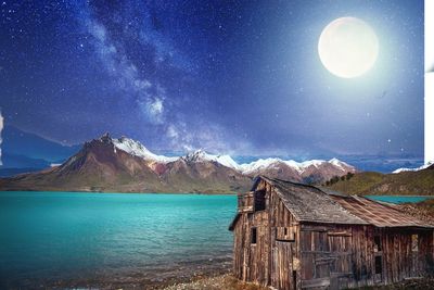 Scenic view of snowcapped mountains against sky at night