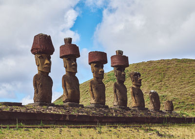 Low angle view of moai statues against sky