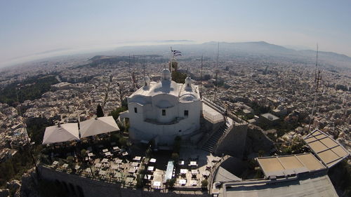 Church of agios georgios on mount lycabettus by residential district against sky