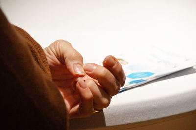 Cropped image of hand on table