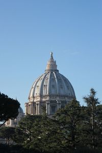 Cathedral by building against clear sky