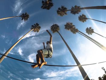 Low angle view of child playing against sky