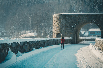 Man standing on snow covered field during winter