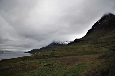 Scenic view of sea and mountains against sky