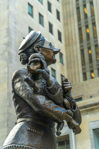 Low angle view of statue against building in city