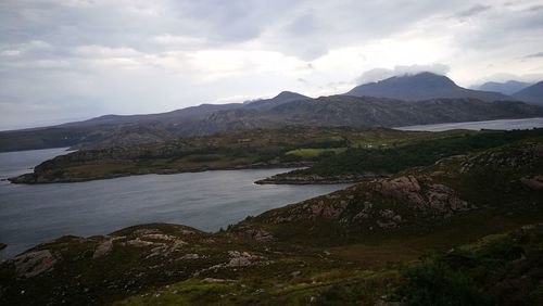 Scenic view of landscape and mountains against sky