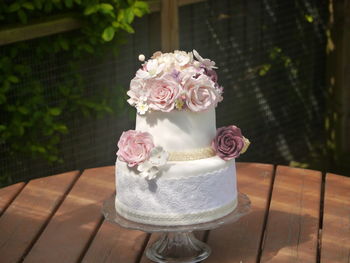 Close-up of cake with floral icing on table