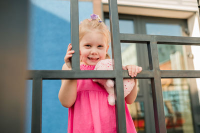 Portrait of cute baby boy looking through window