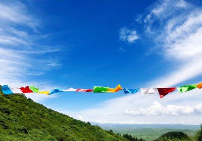 Prayer flags hanging on the mountain with blue sky scenery