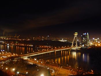 Illuminated cityscape against sky at night