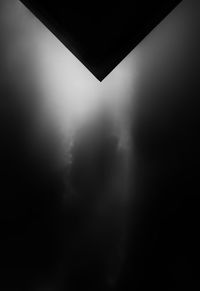 Low angle view of silhouette building against sky at night