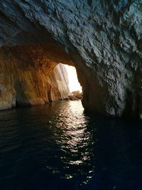 Scenic view of sea seen through cave