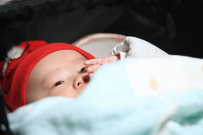 High angle view of cute baby boy lying on bed