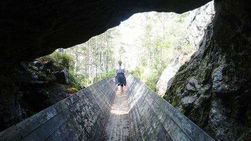 Rear view of woman in cave