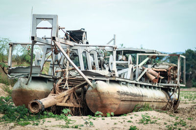 Abandoned truck on field against sky