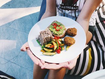 High angle view of woman holding food