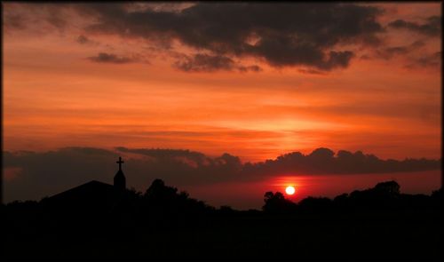 Silhouette of trees against sunset sky