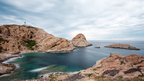 Rocks in sea against sky