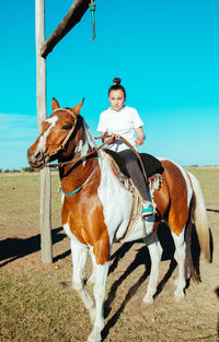 Portrait of girl riding horse